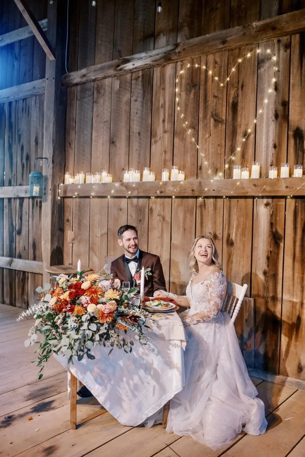 couple at sweetheart table old carter barn