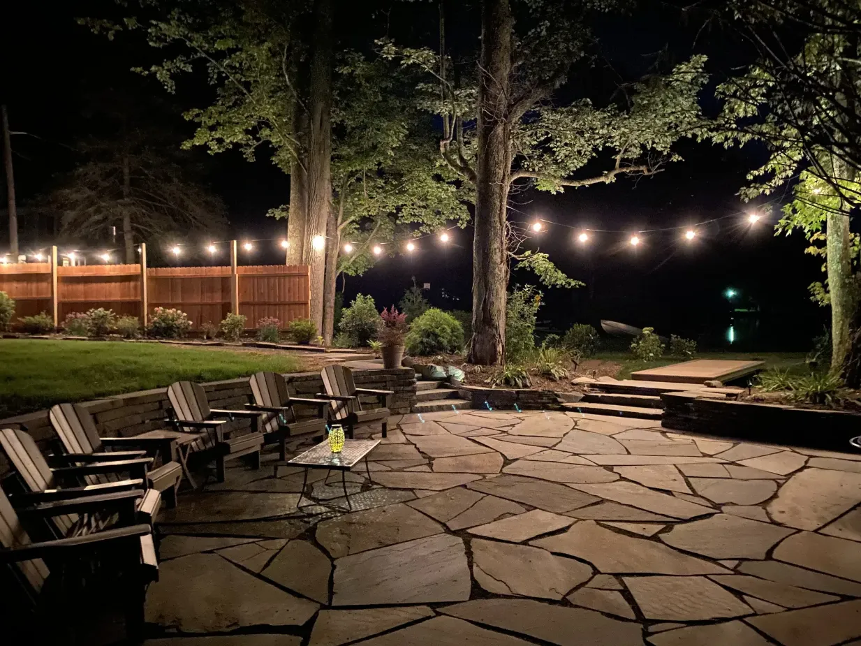 the lake front patio at night with market lights old carter barn